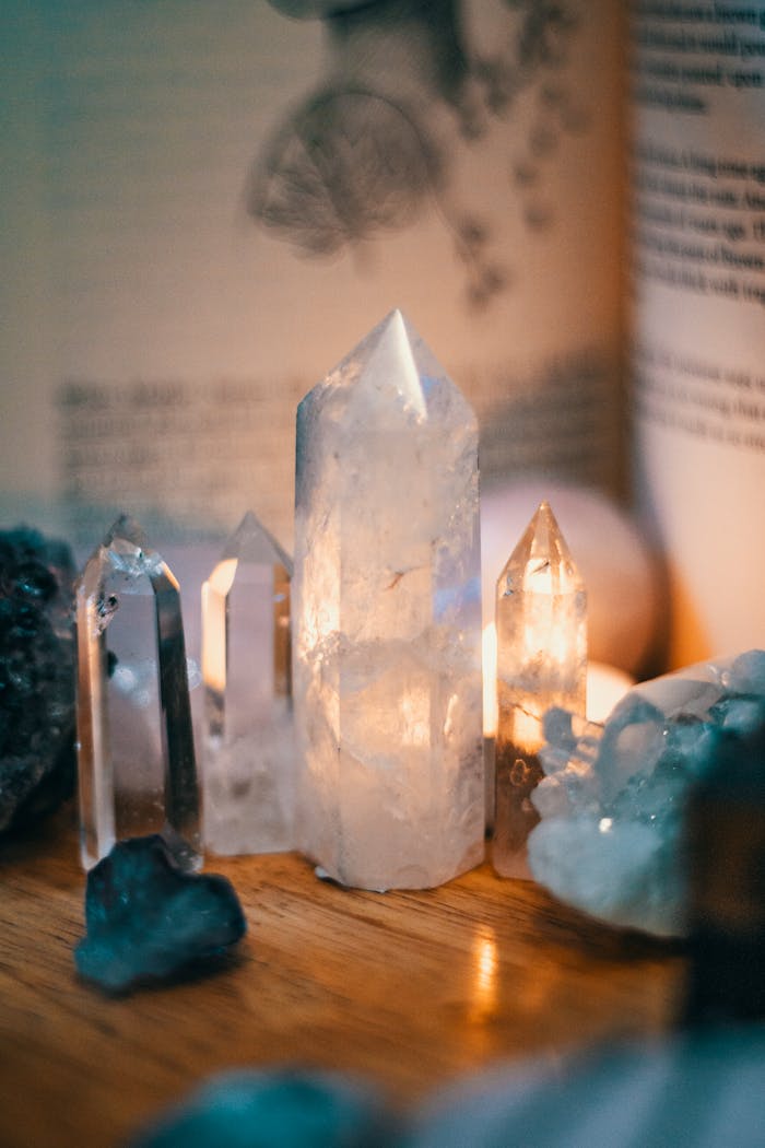 our-services-1 Beautiful quartz crystals displayed on a wooden table with warm ambient lighting.