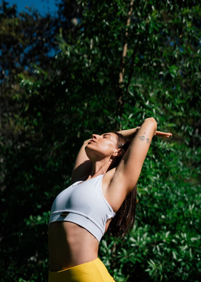 gallery-4 A woman in a yoga pose outdoors, symbolizing a healthy lifestyle and mindfulness.